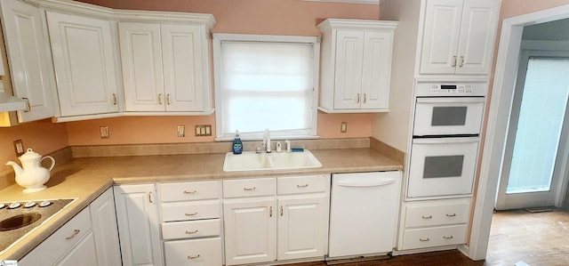 kitchen featuring white cabinetry, white appliances, and sink