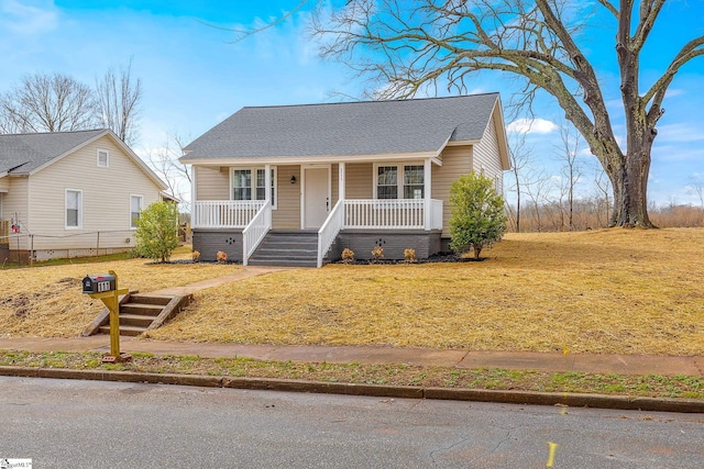 bungalow-style house featuring a porch and a front lawn