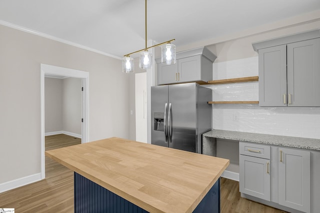 kitchen featuring light hardwood / wood-style flooring, gray cabinetry, light stone counters, tasteful backsplash, and stainless steel fridge with ice dispenser