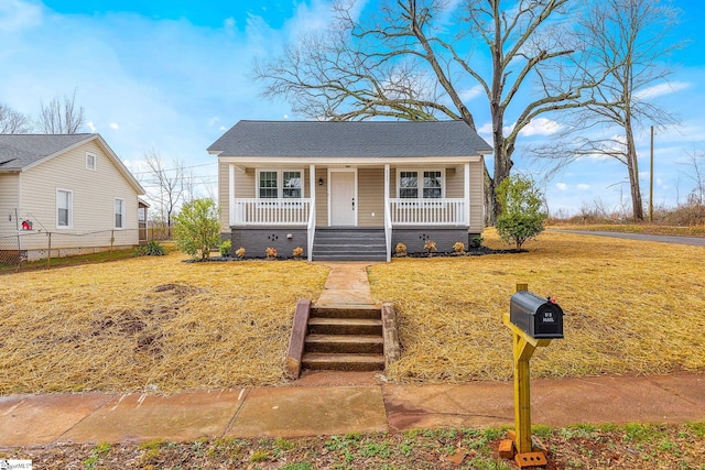 bungalow with a front yard and a porch