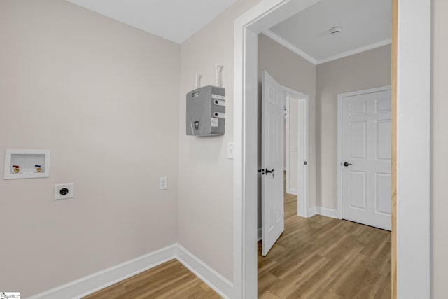 washroom featuring electric dryer hookup, washer hookup, wood-type flooring, and ornamental molding