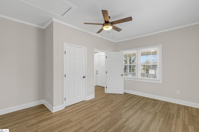 unfurnished bedroom featuring ornamental molding, ceiling fan, and light hardwood / wood-style flooring