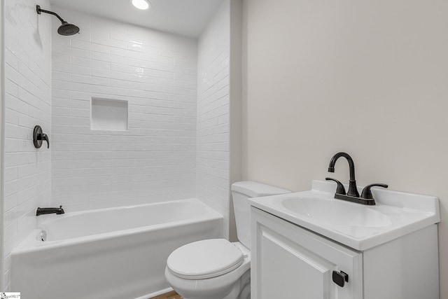 full bathroom with vanity, tiled shower / bath, and toilet