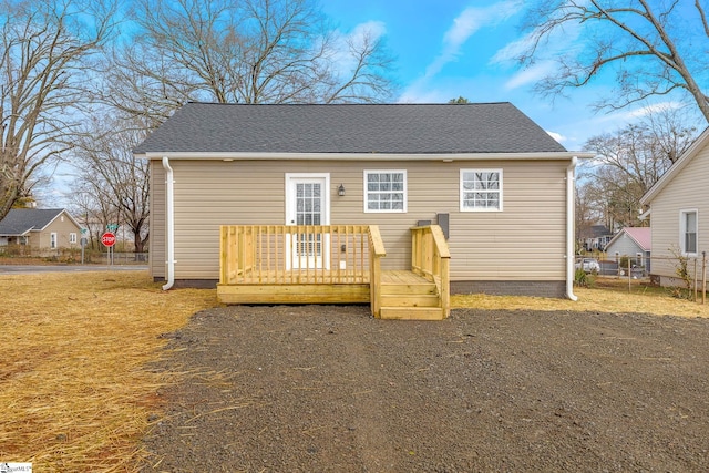 rear view of property with a wooden deck