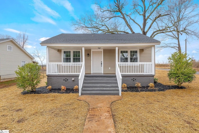 bungalow-style house featuring a front yard and covered porch