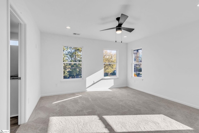 carpeted empty room featuring ceiling fan