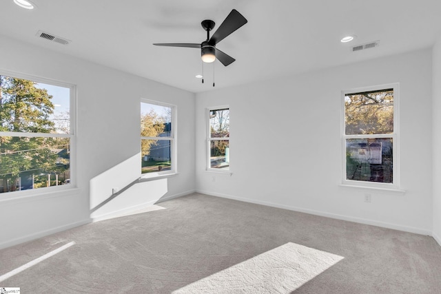 spare room featuring ceiling fan and light colored carpet