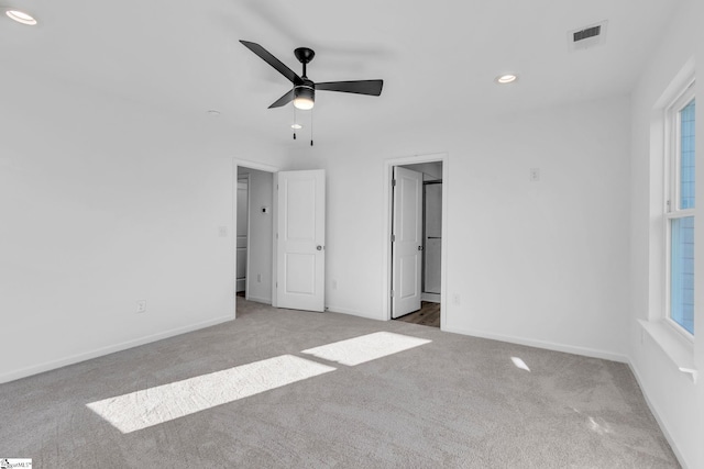 unfurnished bedroom with light colored carpet and ceiling fan