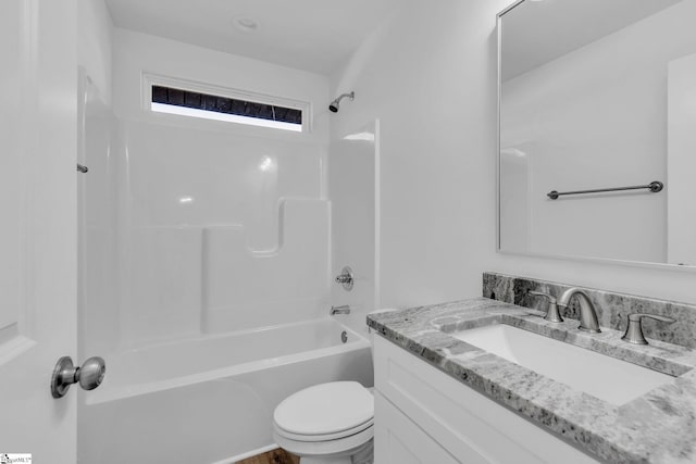 full bathroom featuring washtub / shower combination, vanity, and toilet