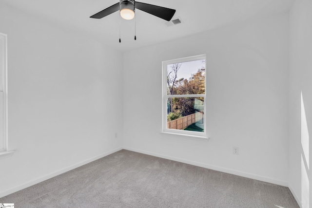 carpeted spare room featuring ceiling fan