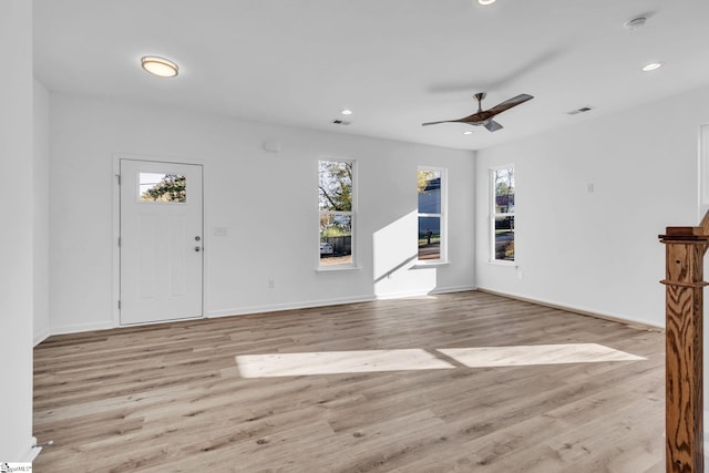 unfurnished living room with a healthy amount of sunlight, ceiling fan, and light hardwood / wood-style flooring