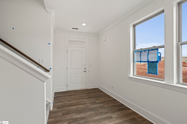 foyer entrance with visible vents, baseboards, stairway, dark wood-style floors, and crown molding