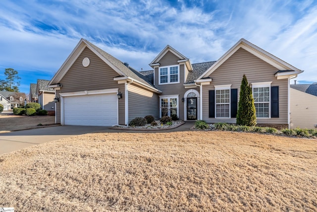 view of front of property with a garage and a front yard