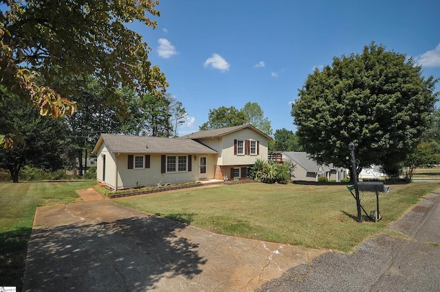 tri-level home with a front lawn
