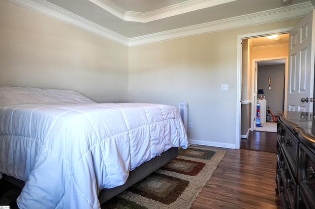 bedroom with crown molding and dark hardwood / wood-style floors