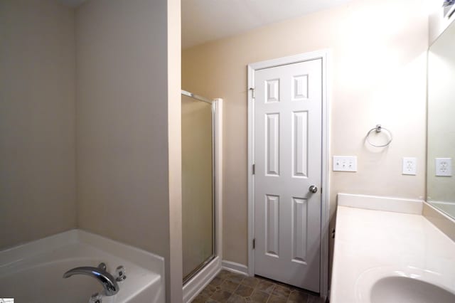 bathroom featuring shower with separate bathtub and vanity