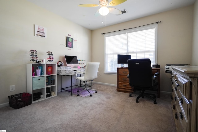 carpeted office space featuring ceiling fan