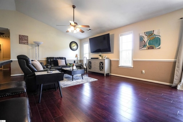 living room with lofted ceiling, a healthy amount of sunlight, and dark hardwood / wood-style flooring