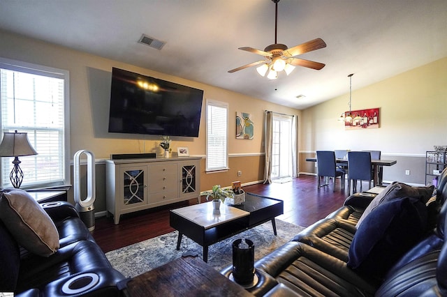 living room featuring dark hardwood / wood-style flooring, vaulted ceiling, and ceiling fan