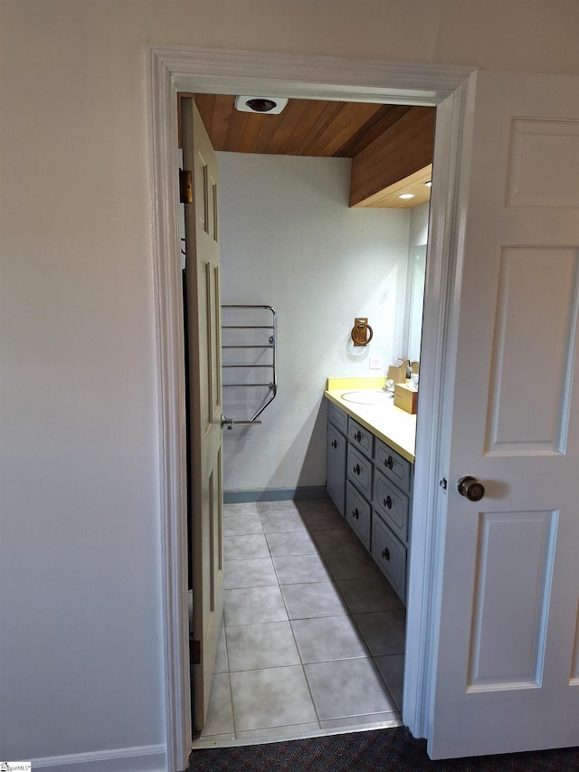 bathroom featuring tile patterned flooring, wood ceiling, radiator heating unit, and vanity