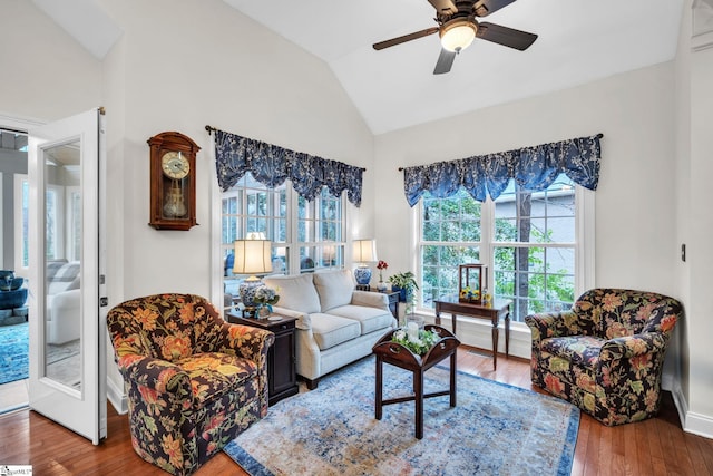 living room with ceiling fan, lofted ceiling, and hardwood / wood-style floors