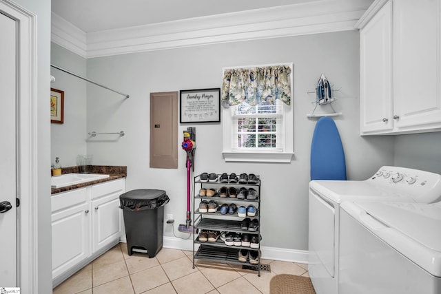 laundry area with sink, light tile patterned floors, electric panel, cabinets, and washer and dryer