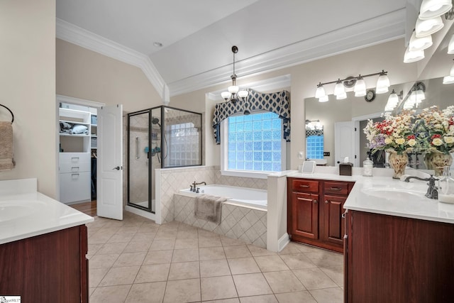 bathroom with crown molding, vanity, plus walk in shower, vaulted ceiling, and tile patterned floors