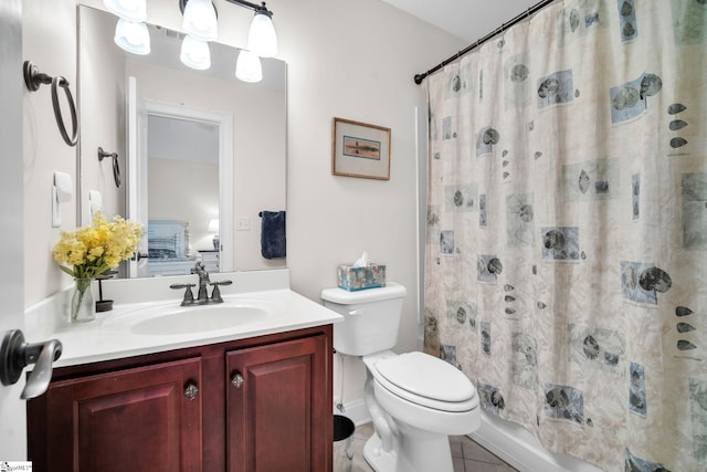 bathroom featuring tile patterned flooring, vanity, and toilet