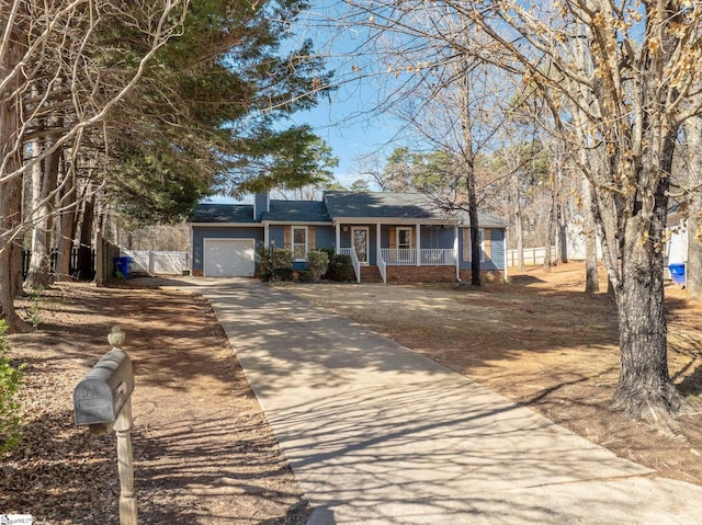 single story home with a garage and covered porch