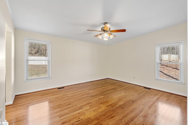 empty room with light hardwood / wood-style floors and ceiling fan