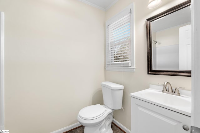 bathroom featuring ornamental molding, vanity, and toilet