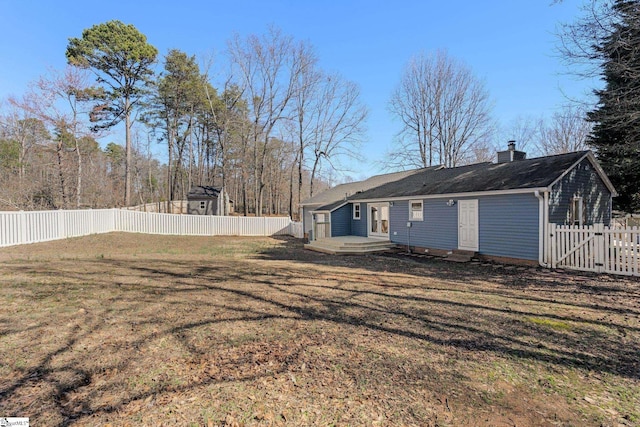 rear view of house featuring a lawn