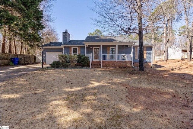 ranch-style home with a garage and a porch