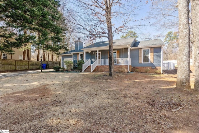 ranch-style house with a garage and covered porch