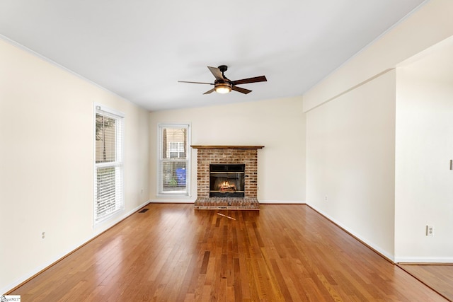 unfurnished living room featuring ceiling fan, lofted ceiling, hardwood / wood-style floors, and a fireplace