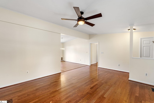 empty room featuring hardwood / wood-style flooring, vaulted ceiling, and ceiling fan