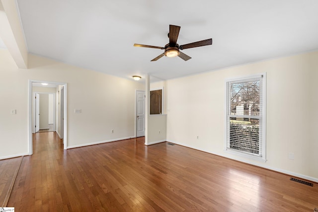 empty room featuring hardwood / wood-style flooring and ceiling fan