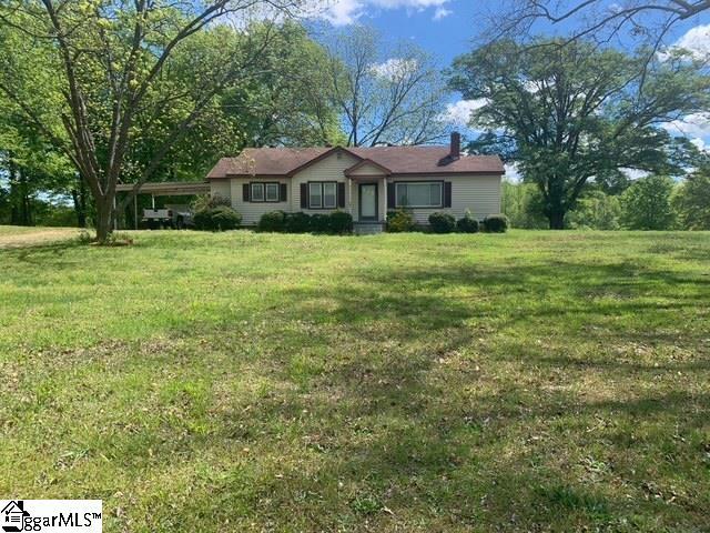 single story home with a front yard and a chimney