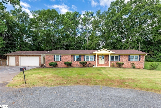 single story home featuring a garage and a front lawn