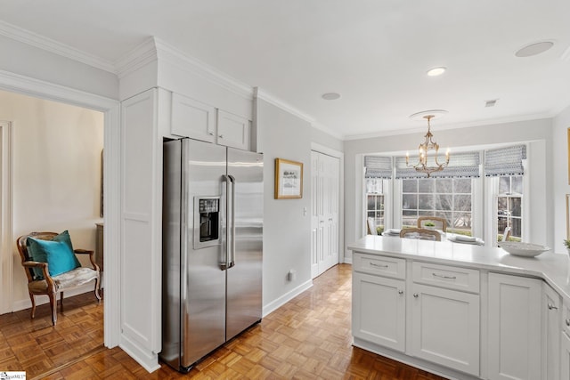 kitchen featuring light parquet floors, decorative light fixtures, white cabinets, and stainless steel fridge with ice dispenser