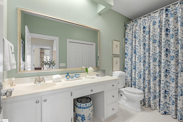 bathroom with vanity, curtained shower, tile patterned floors, and toilet