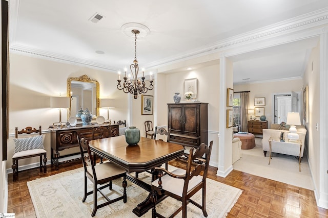 dining space featuring ornamental molding, parquet floors, and a notable chandelier