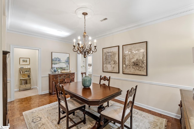 dining area with crown molding, parquet flooring, and an inviting chandelier