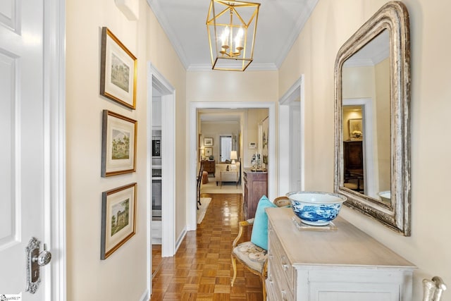 hall with crown molding, a chandelier, and light parquet floors