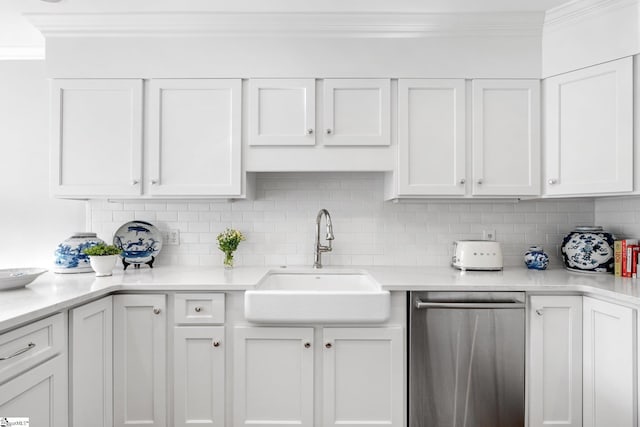 kitchen with sink, crown molding, dishwasher, decorative backsplash, and white cabinets