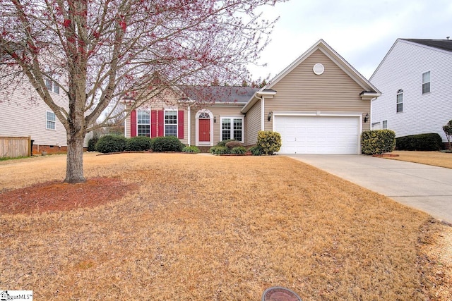 view of front of home featuring a garage and a front yard