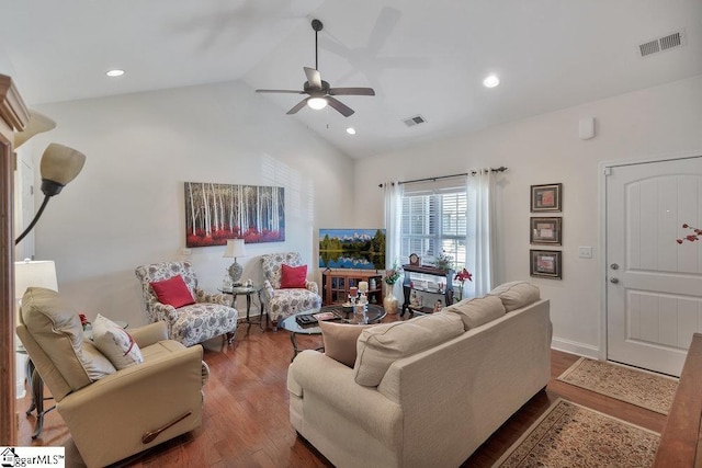 living room featuring dark wood-type flooring, ceiling fan, and vaulted ceiling