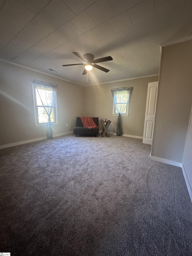 unfurnished room featuring crown molding, a healthy amount of sunlight, and carpet flooring