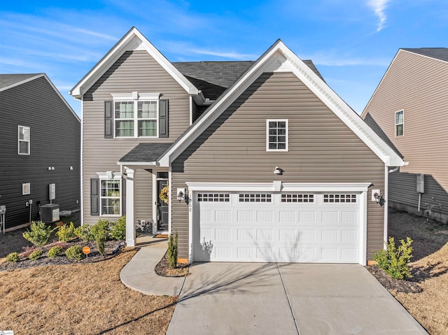 view of front of home featuring a garage and central AC