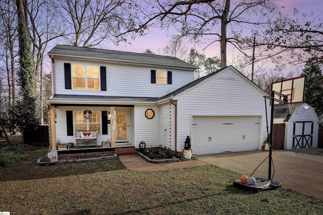 view of front property with a garage, a yard, covered porch, and a storage shed